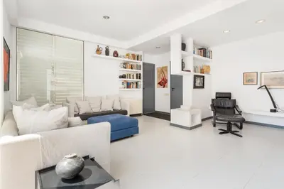 a living room with a couch and a chair at Casa Mediterránea con jardín y piscina privada in Masnou