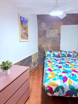 a bedroom with a bed and a dresser in it at Stunning flat for 6 people 3 blocks from the beach plus welcome breakfast in Barcelona