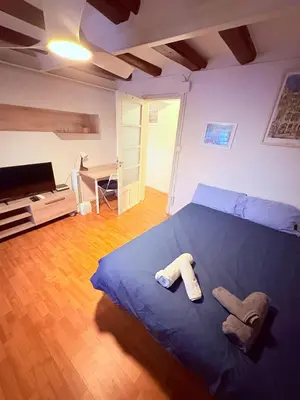 a bedroom with a blue bed with two towels on it at Stunning flat for 6 people 3 blocks from the beach plus welcome breakfast in Barcelona