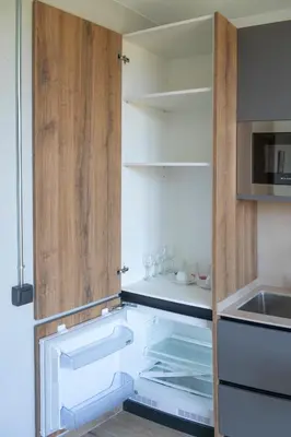 a kitchen with an open door to a refrigerator at Monturiol Apartaments in Barcelona