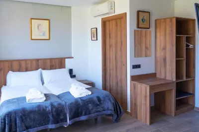 a bedroom with a bed with two towels on it at Monturiol Apartaments in Barcelona