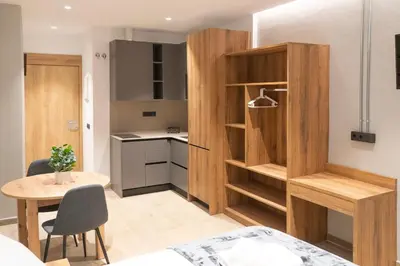 a small apartment with a small table and a kitchen at Monturiol Apartaments in Barcelona