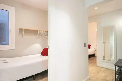 a white room with a bed and a window at Habitat Apartments Pau in Barcelona