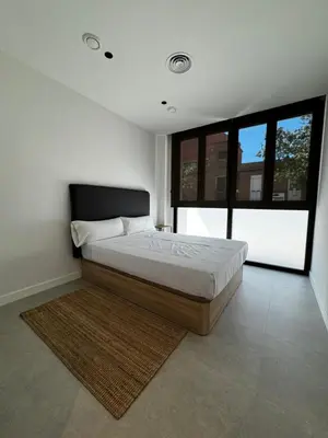 a bedroom with a bed and a large window at Comfortwork near Barcelona in Sant Quirze del Vallès