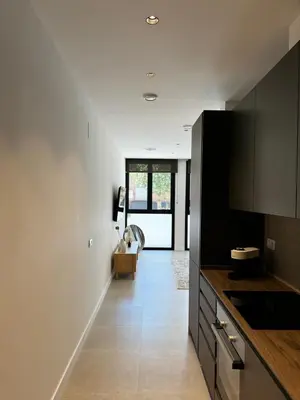 a kitchen with white walls and black cabinets at Comfortwork near Barcelona in Sant Quirze del Vallès