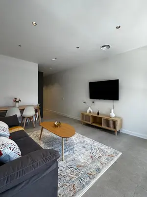 a living room with a couch and a tv on a wall at Comfortwork near Barcelona in Sant Quirze del Vallès