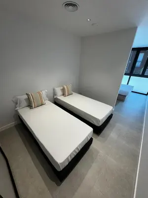 two beds in a room with white walls at Comfortwork near Barcelona in Sant Quirze del Vallès