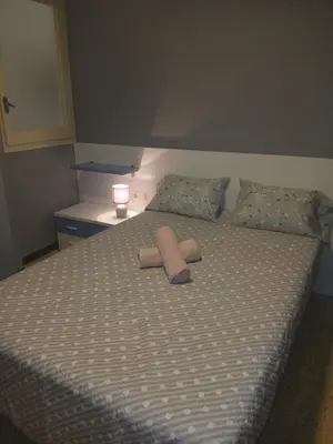 a bed with two towels on top of it at Primera linea in Cunit