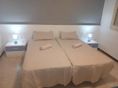 a bedroom with a bed with two pillows on it at Primera linea in Cunit