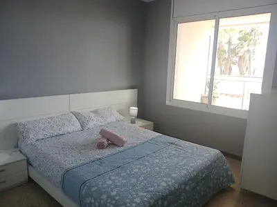 a bedroom with a bed with a teddy bear on it at Primera linea in Cunit
