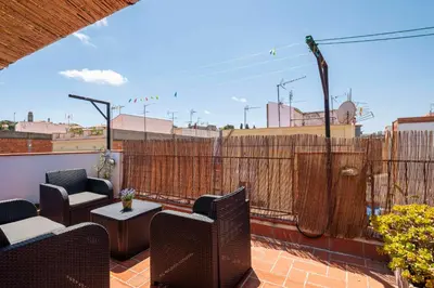 a patio with chairs and tables on a balcony at Atico con Terraza en Fira Barcelona - Negocios y Turismo en Sants - Montjuic in Barcelona