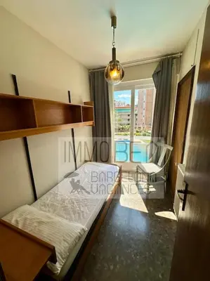 a bedroom with a bed and a chair and a window at BV-SV-002-Mediterrani in Sant Andreu de Llavaneres