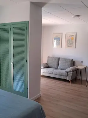 a living room with a couch and a bed at Hotel Mediterrani Express in Calella