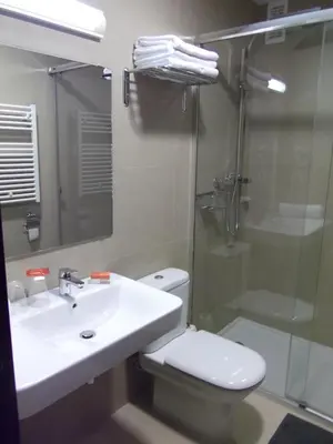a bathroom with a toilet and a sink and a shower at Hotel Mediterrani Express in Calella
