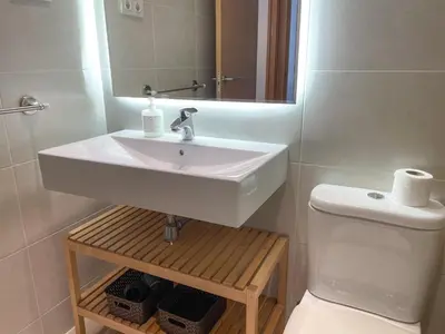a bathroom with a sink and a toilet at Apartment Marina in Vilanova i la Geltrú