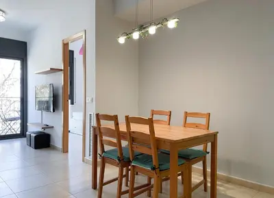 a dining room with a wooden table and chairs at Apartment Marina in Vilanova i la Geltrú