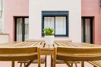 a wooden table with a potted plant on it at Novus Homes Barcelona Santa Eulalia in Hospitalet de Llobregat