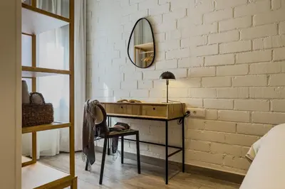 a dressing room with a desk and a mirror at Novus Homes Barcelona Santa Eulalia in Hospitalet de Llobregat
