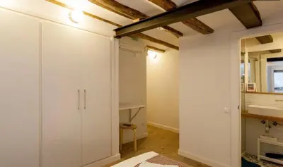 a bathroom with white cabinets and a sink in a room at Las Ramblas Apartments Old Town in Barcelona