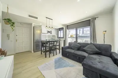 a living room with a couch and a table at HomeHolidaysRentals Kala - Costa Barcelona in Pineda de Mar