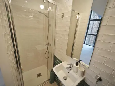 a bathroom with a sink and a shower at Antic Manresa Atico in Manresa