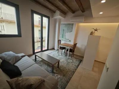 a living room with a couch and a table at Antic Manresa Atico in Manresa