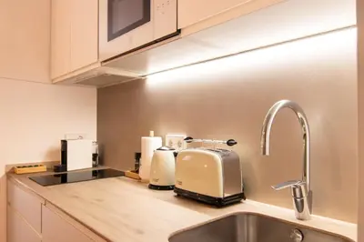 a kitchen counter with a toaster and a sink at Stay U-nique Apartment Comte Güell in Barcelona