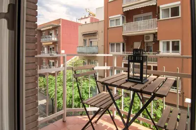 a balcony with a bench and a view of some buildings at Stay U-nique Apartment Comte Güell in Barcelona