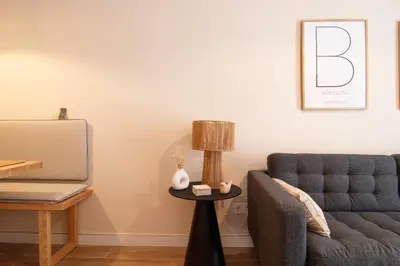 a living room with a couch and a table with a lamp at Stay U-nique Apartment Comte Güell in Barcelona