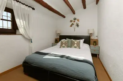 a bedroom with a large bed in a room at Cal Mingo in Viladellops