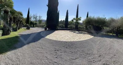 a walkway in a park with trees and a road at Cal Mingo in Viladellops