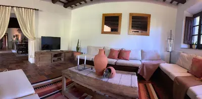 a living room with a couch and a tv at Cal Mingo in Viladellops