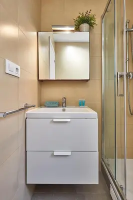 a bathroom with a white sink and a mirror at BBarcelona Urban Apartments in Barcelona