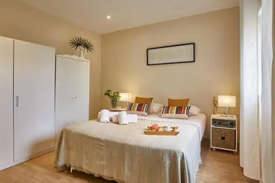 a bedroom with a bed with a tray on it at BBarcelona Urban Apartments in Barcelona