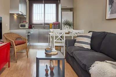 a living room with a couch and a table at BBarcelona Urban Apartments in Barcelona