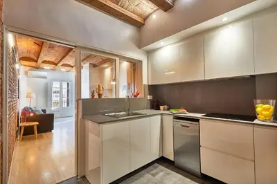 a kitchen with white cabinets and a sink at BBarcelona Urban Apartments in Barcelona