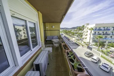 a balcony with a view of a city at HomeholidayRentals Singular - Costa Barcelona in Pineda de Mar