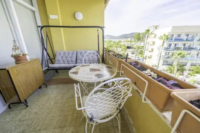 a balcony with a table and chairs on a balcony at HomeholidayRentals Singular - Costa Barcelona in Pineda de Mar