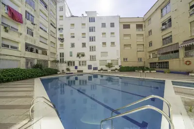 a swimming pool in an apartment complex with buildings at HomeholidayRentals Singular - Costa Barcelona in Pineda de Mar