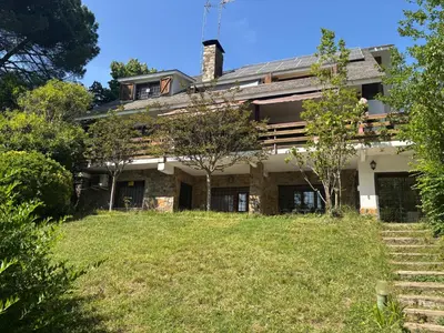 an old house with a grassy yard in front of it at Vivenda de luxe a Barcelona in Sant Cugat del Vallès