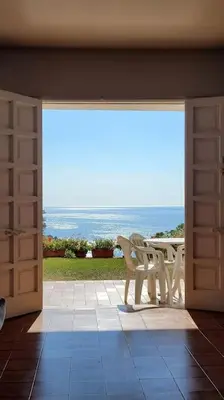 an open door to a patio with a table and a view at Casa perfecta con vistas al Mar in San Pol de Mar