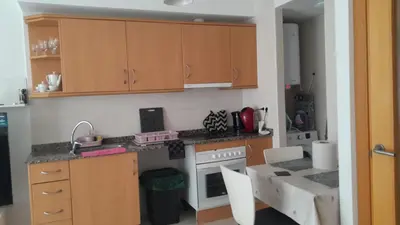 a living room with a large television and a table at STUDIO VILAFRANCA DEL PENEDES in Vilafranca del Penedès