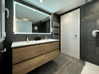 a bathroom with a sink and a mirror at Urban Waves by Hello Homes Sitges in Sitges
