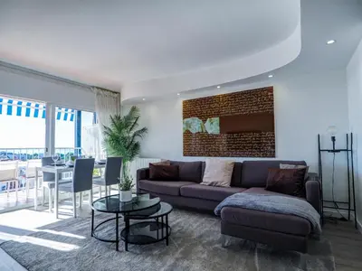 a living room with a couch and a table at Urban Waves by Hello Homes Sitges in Sitges