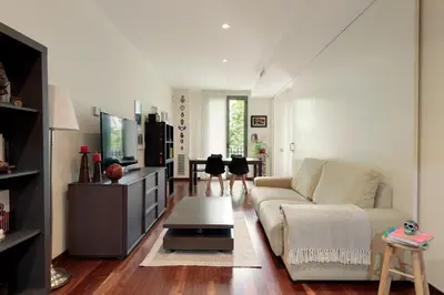 a living room with a couch and a table at Frida by EnjoyApartments in Barcelona