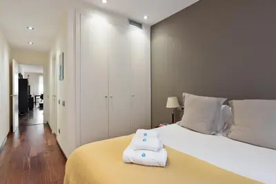 a bedroom with a white bed with towels on it at Frida by EnjoyApartments in Barcelona