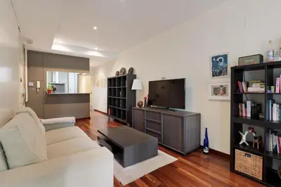 a living room with a couch and a tv at Frida by EnjoyApartments in Barcelona