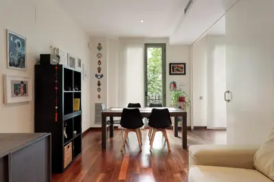 a living room with a dining room table and chairs at Frida by EnjoyApartments in Barcelona