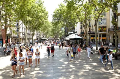 a crowd of people walking down a city street at Hotel Continental Barcelona in Barcelona