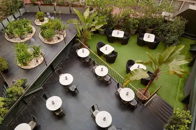 an overhead view of tables and chairs in a garden at Hotel Continental Barcelona in Barcelona